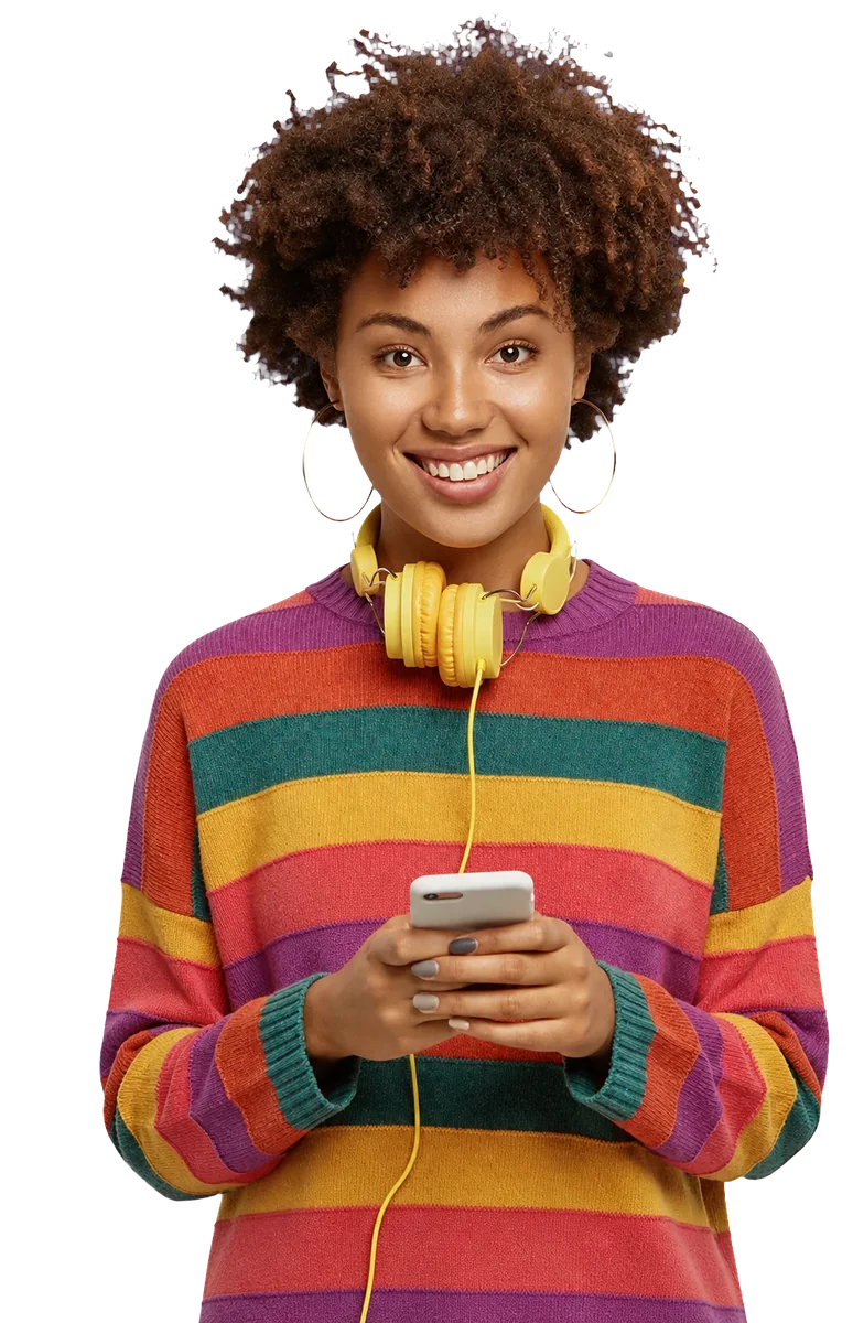A smiling woman holding her phone, headphones around her neck